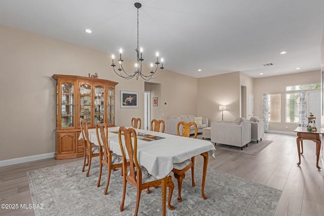 dining area featuring light wood-type flooring, baseboards, visible vents, and recessed lighting