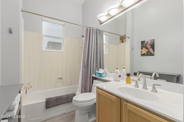 full bath with a healthy amount of sunlight, toilet, shower / bath combo with shower curtain, and vanity