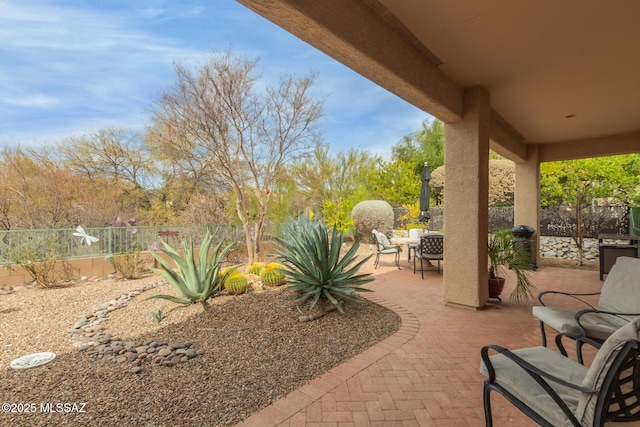 view of patio featuring an outdoor fire pit and a fenced backyard