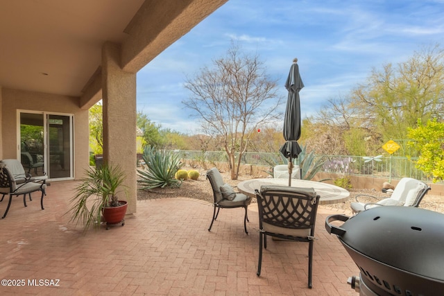 view of patio / terrace with a grill, a fenced backyard, and outdoor dining space