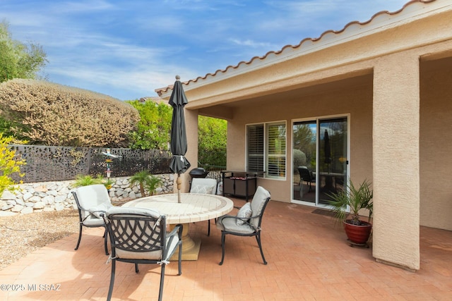 view of patio / terrace with outdoor dining area and fence