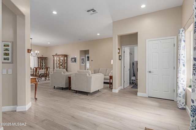 living room with light wood-style flooring, recessed lighting, visible vents, baseboards, and an inviting chandelier