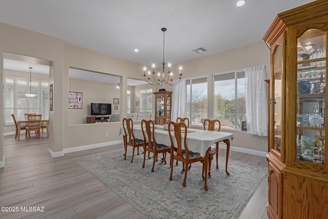 dining room with light wood-style flooring, recessed lighting, visible vents, baseboards, and an inviting chandelier