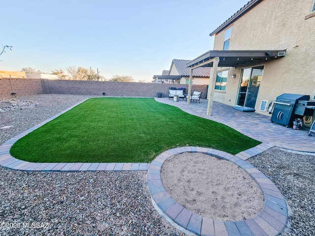 view of yard featuring a patio area and a fenced backyard