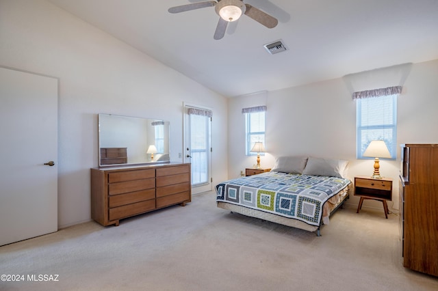 bedroom with ceiling fan, light colored carpet, and vaulted ceiling