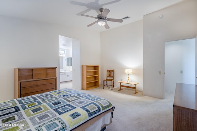 bedroom featuring light colored carpet and ensuite bathroom