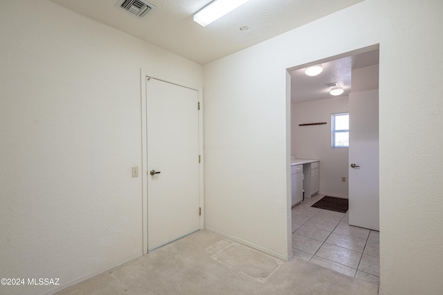 corridor featuring light tile patterned flooring