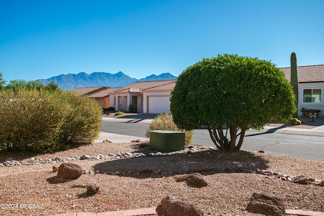 view of front of house featuring a garage and a mountain view