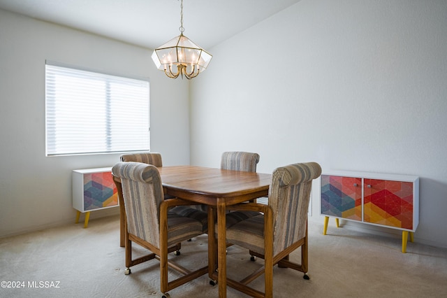 dining area featuring light colored carpet and a notable chandelier