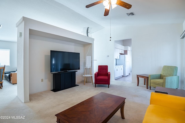 living room featuring ceiling fan, lofted ceiling, and light carpet