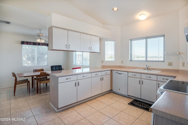 kitchen with sink, white appliances, light tile patterned floors, white cabinetry, and kitchen peninsula