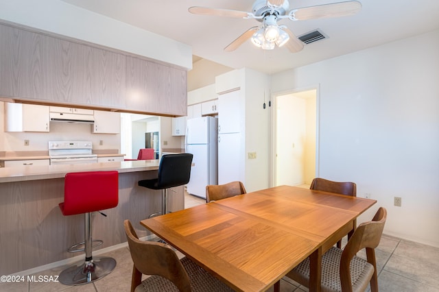 dining space featuring light tile patterned floors and ceiling fan