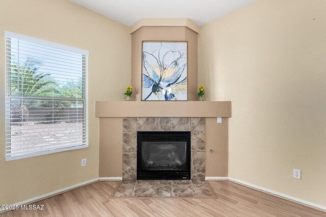 12996 N Desert Olive Dr, Oro Valley, AZ 85755 - interior details featuring wood-type flooring and a tile fireplace