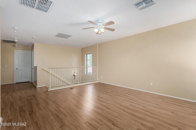 12996 N Desert Olive Dr, Oro Valley, AZ 85755 - empty room with ceiling fan and wood-type flooring