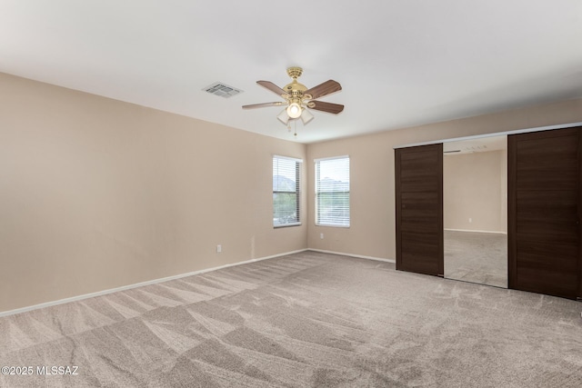 12996 N Desert Olive Dr, Oro Valley, AZ 85755 - unfurnished bedroom with light carpet, ceiling fan, and a closet