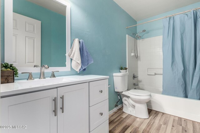 12996 N Desert Olive Dr, Oro Valley, AZ 85755 - full bathroom with shower / bathtub combination with curtain, wood-type flooring, toilet, and vanity