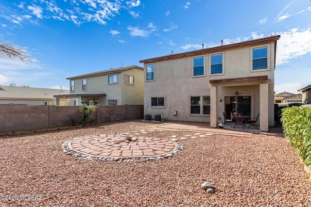 12996 N Desert Olive Dr, Oro Valley, AZ 85755 - rear view of property featuring central AC unit and a patio