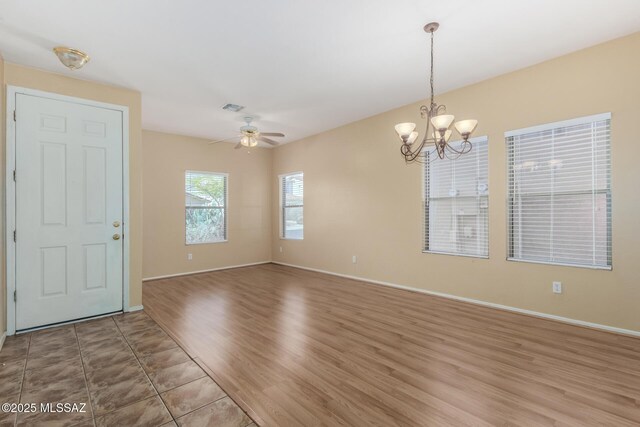 12996 N Desert Olive Dr, Oro Valley, AZ 85755 - unfurnished room featuring hardwood / wood-style flooring and ceiling fan with notable chandelier