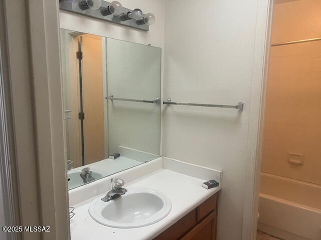 bathroom with vanity and bathing tub / shower combination