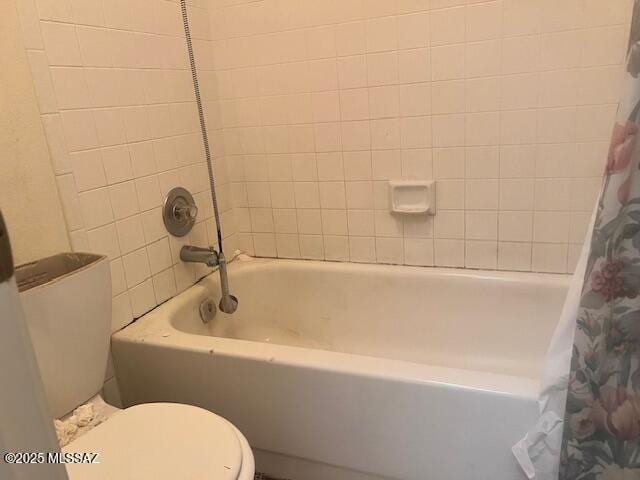 bathroom with shower / tub combo with curtain and toilet