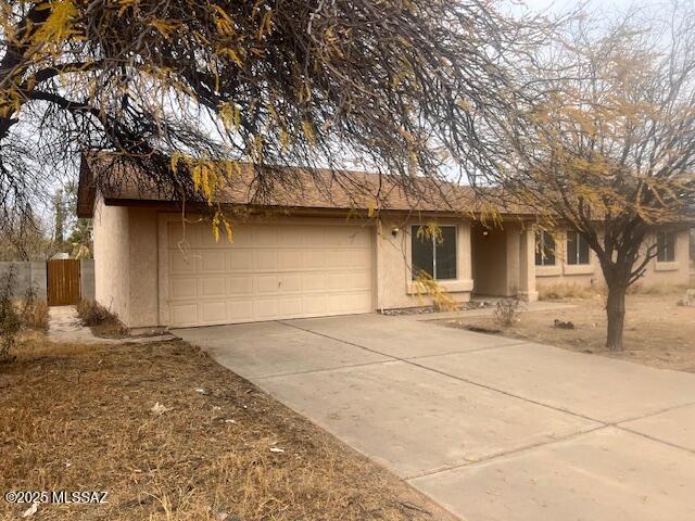 ranch-style house featuring a garage