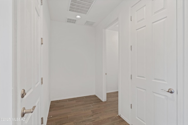 hall featuring recessed lighting, visible vents, baseboards, and dark wood-style floors