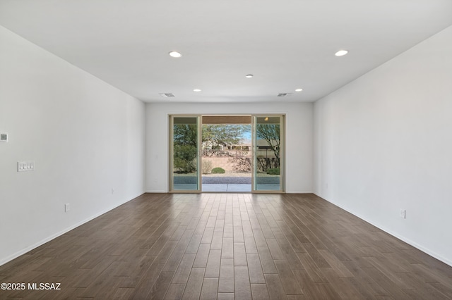 unfurnished room featuring recessed lighting, baseboards, and dark wood-style floors