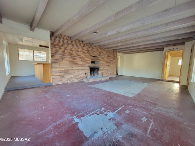 unfurnished living room featuring a fireplace and beamed ceiling