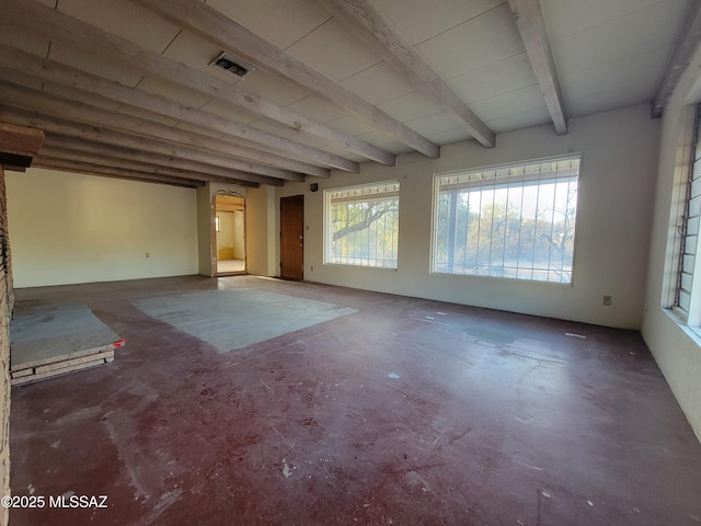 empty room with beamed ceiling