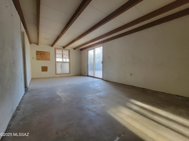 unfurnished room featuring beam ceiling