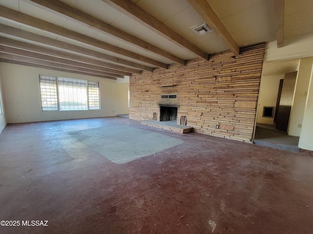 unfurnished living room with a fireplace, concrete flooring, and beam ceiling