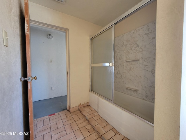 bathroom with shower / bath combination with glass door