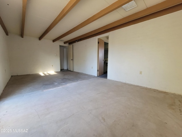 empty room featuring beamed ceiling