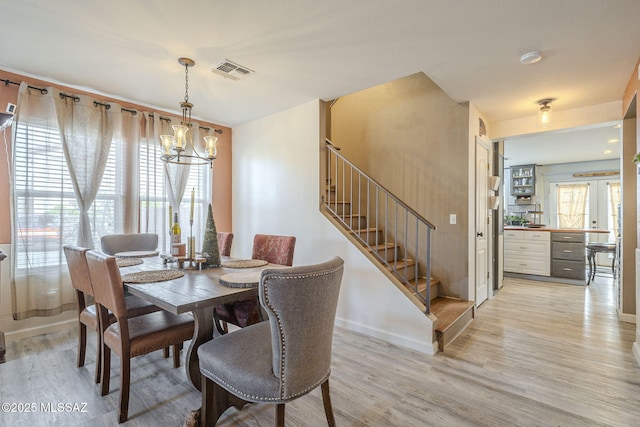 dining room with a chandelier and light hardwood / wood-style flooring