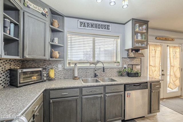 kitchen with sink, decorative backsplash, stainless steel dishwasher, and french doors