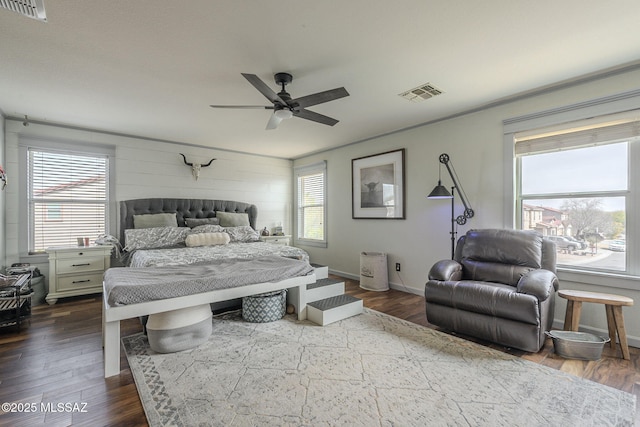 bedroom with hardwood / wood-style flooring, ceiling fan, and multiple windows
