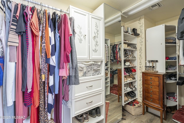 spacious closet featuring hardwood / wood-style floors