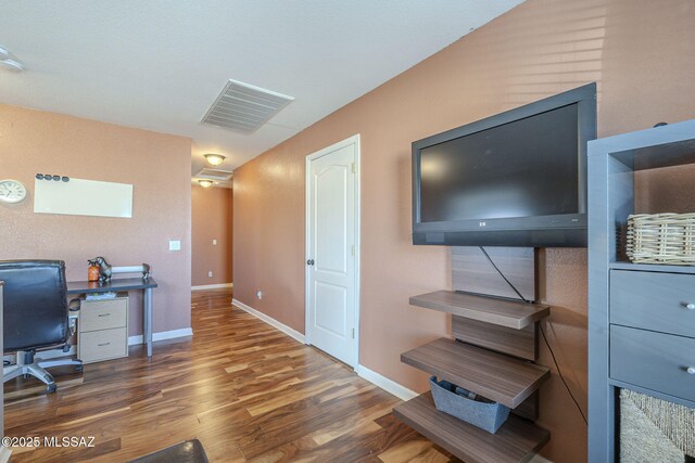 home office with dark hardwood / wood-style flooring