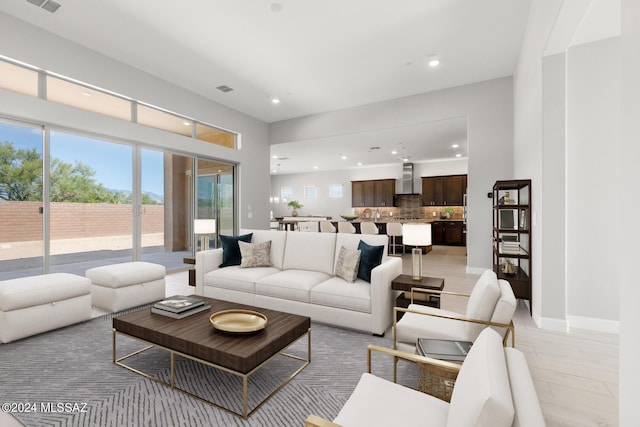 living room with a wealth of natural light and light hardwood / wood-style floors