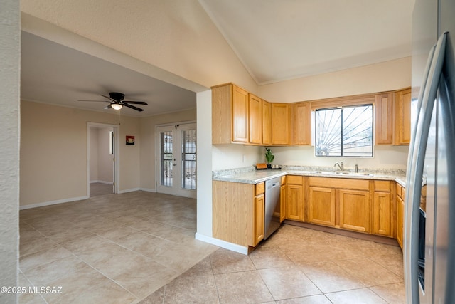 kitchen with ceiling fan, vaulted ceiling, appliances with stainless steel finishes, and light tile patterned floors