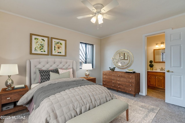 bedroom featuring ensuite bathroom, light colored carpet, and ornamental molding