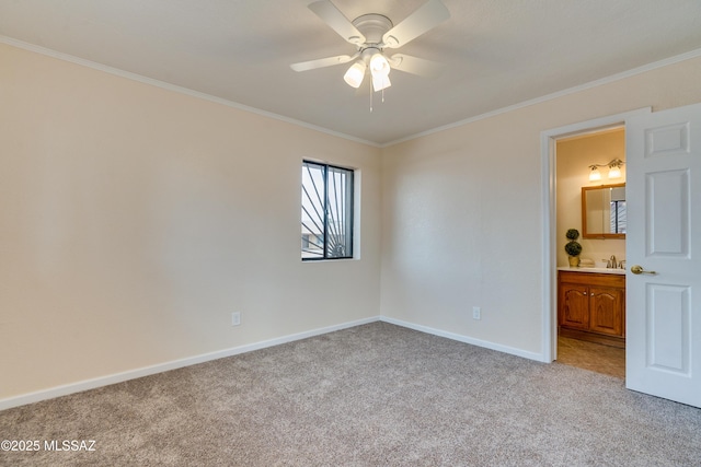 empty room with a ceiling fan, light carpet, ornamental molding, and baseboards