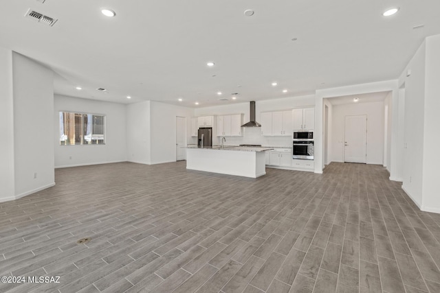 unfurnished living room featuring sink and light wood-type flooring