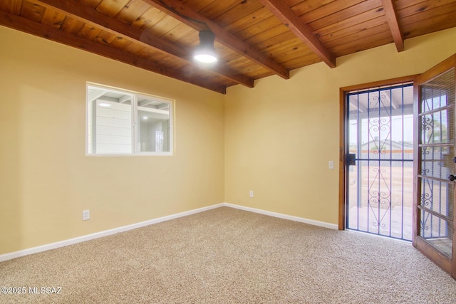 carpeted spare room with beamed ceiling and wood ceiling