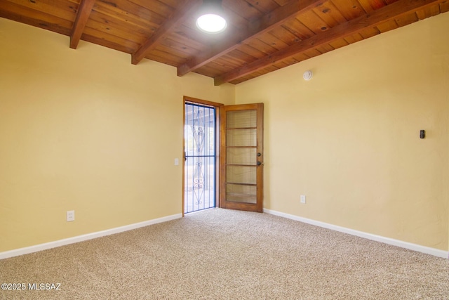 carpeted empty room featuring wood ceiling and lofted ceiling with beams