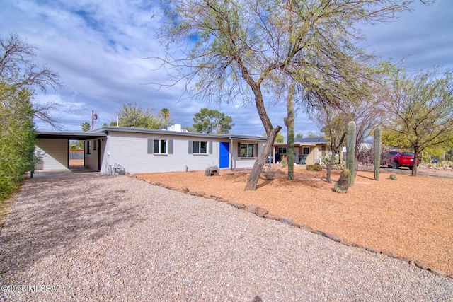 ranch-style house featuring a carport