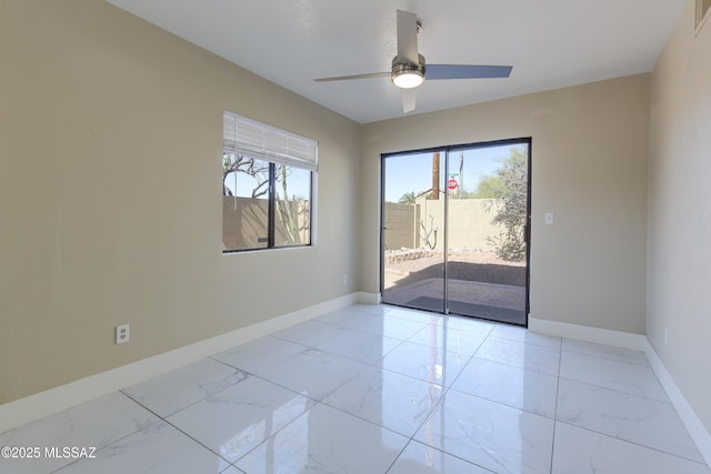 spare room featuring visible vents, baseboards, marble finish floor, and ceiling fan