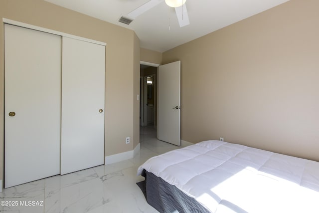 bedroom with visible vents, baseboards, ceiling fan, a closet, and marble finish floor