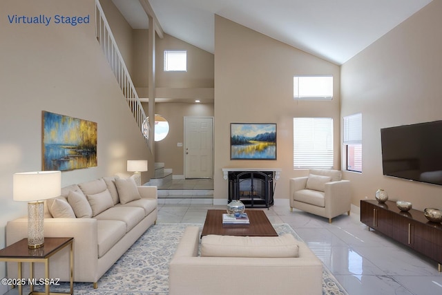 living room with baseboards, stairway, vaulted ceiling, a fireplace, and marble finish floor