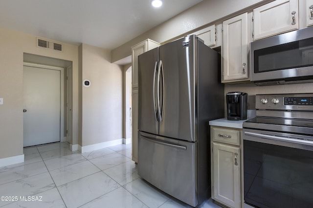 kitchen with visible vents, baseboards, light countertops, appliances with stainless steel finishes, and marble finish floor